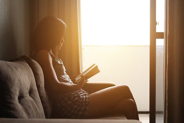 student reading FAQ on laptop dark education website